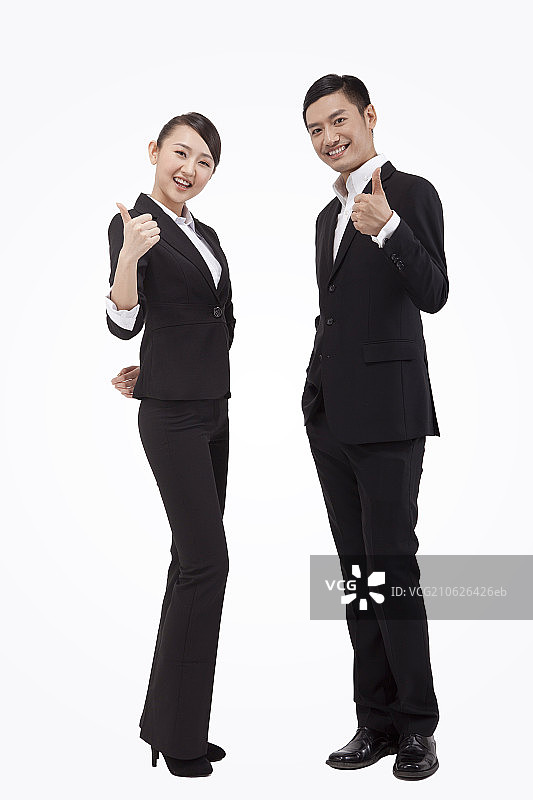 年轻商务男士和女士翘起大拇指图片素材