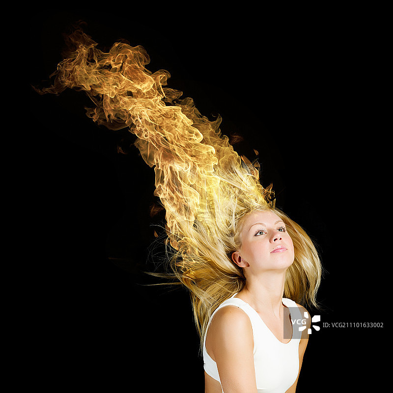 头发火。年轻迷人的金发女孩，头发燃烧着火焰图片素材