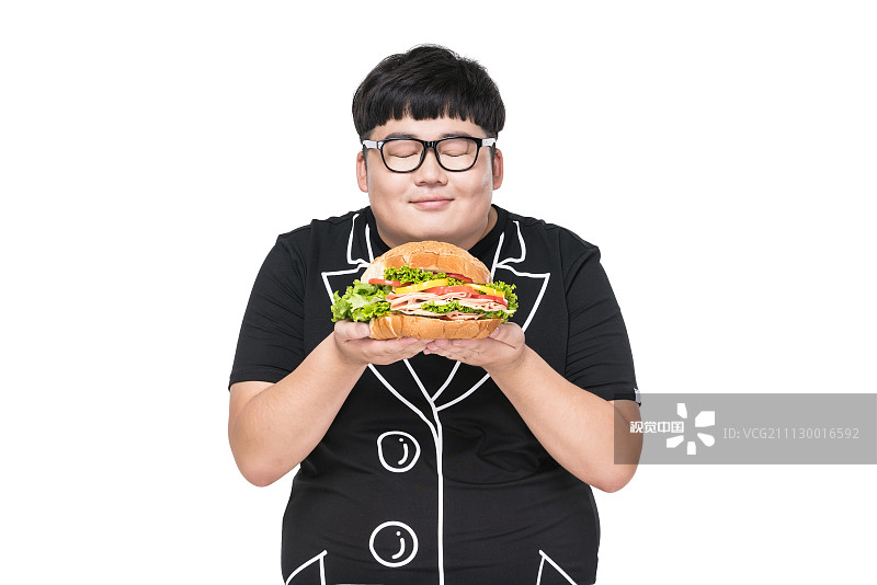 拿着美食的肥胖青年男子图片素材