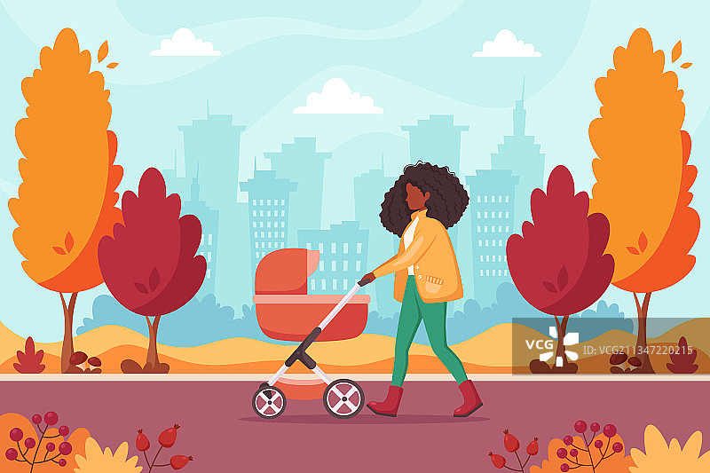一个黑人妇女在秋天推着婴儿车散步图片素材