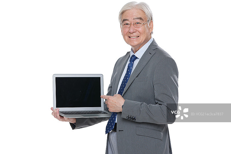 一个成功的老年男人拿着笔记本电脑图片素材