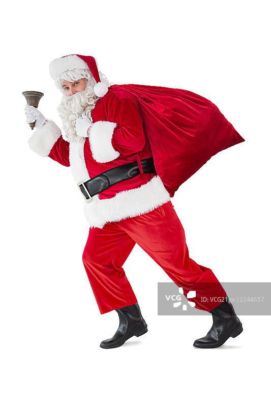 圣诞老人带着他的口袋和铃铛走在白色的背景上图片素材