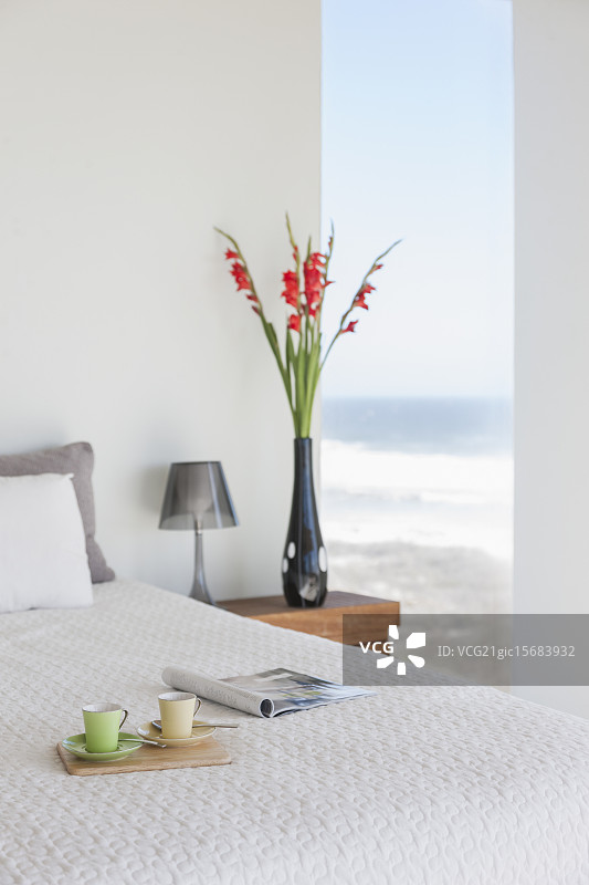 早餐托盘在床上的现代卧室与海景图片素材