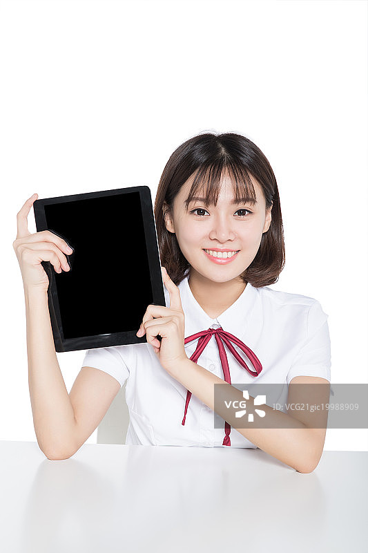 美丽的女学生举着平板电脑图片素材