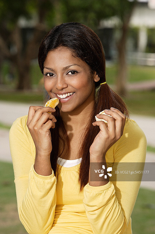 在外面吃橘子的女人图片素材