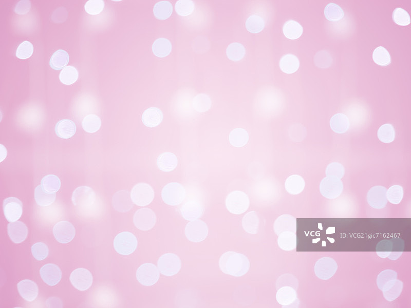 散焦的圣诞灯在粉红色的背景图片素材