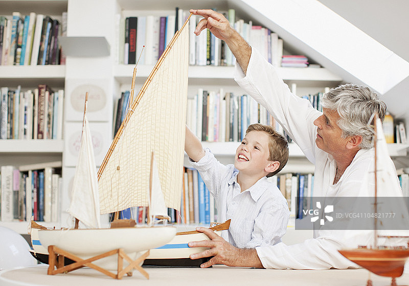 爷爷和孙子在看帆船模型图片素材