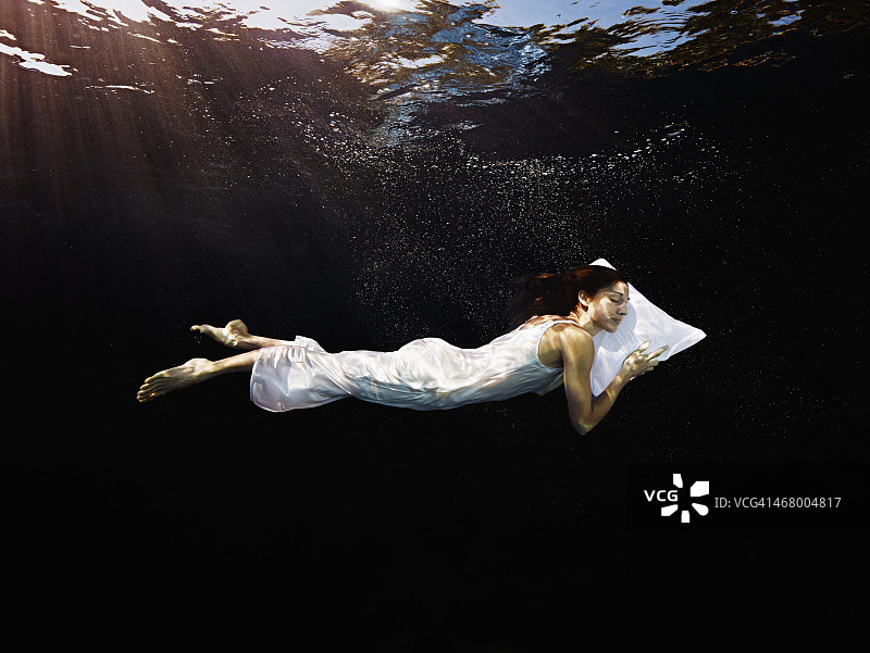 一个枕着枕头在水下睡觉的女人图片素材