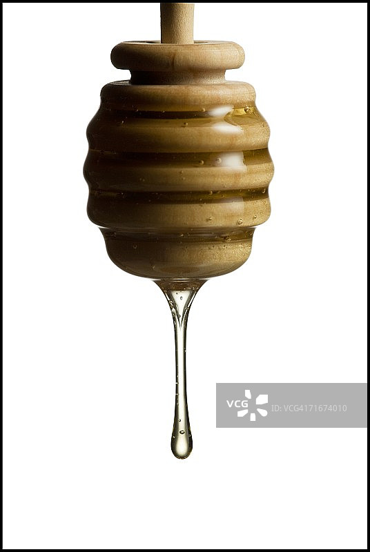 从蜂蜜勺上掉下的蜂蜜图片素材
