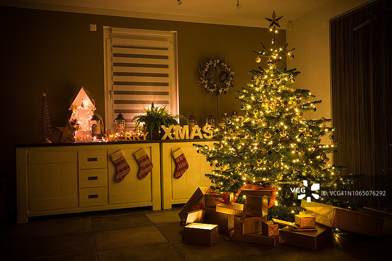 装饰着小装饰品、彩灯和礼物的圣诞树图片素材