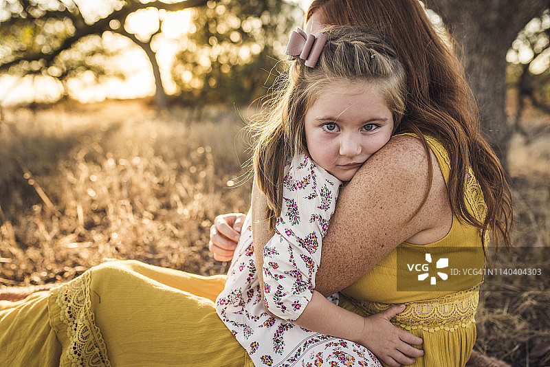 年轻女孩的近距离拥抱母亲在加利福尼亚的田野图片素材