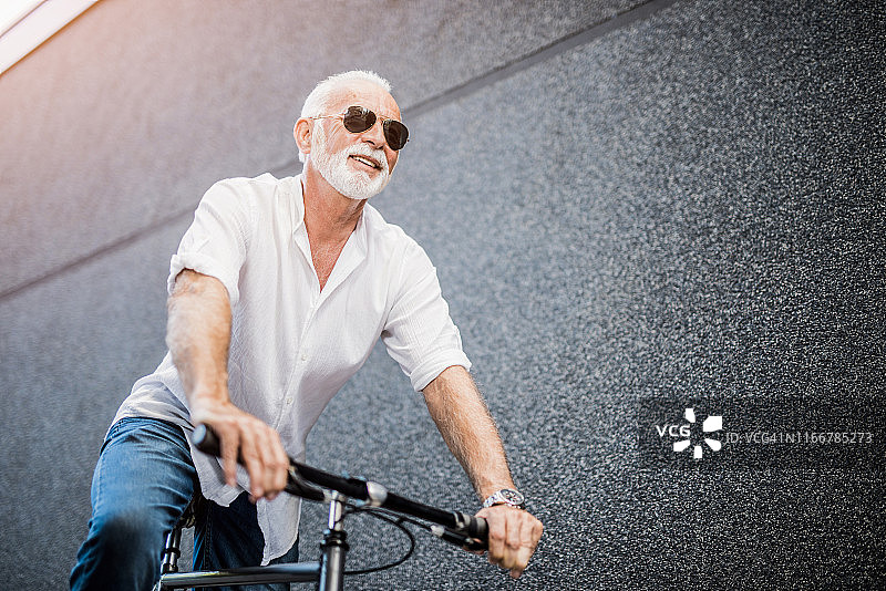 快乐的老人骑着自行车。图片素材
