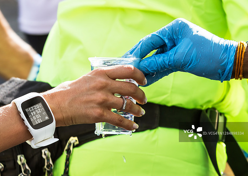 马拉松运动员伸手拿饮料杯图片素材