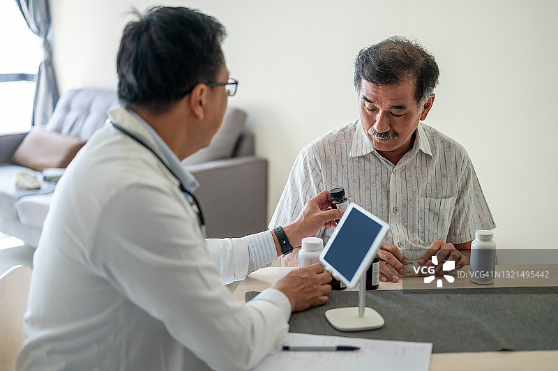 一位亚洲男性医生在医疗诊所咨询成熟的病人图片素材