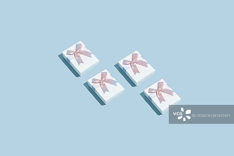 四个蓝色背景的白色礼品盒图片素材