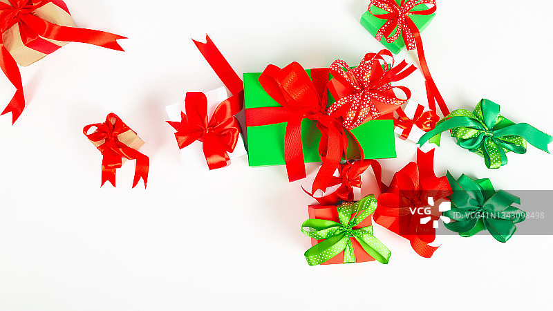 圣诞快乐和节日快乐贺卡。圣诞礼物和红色装饰在白色的背景顶部视图。新年的概念。平躺图片素材