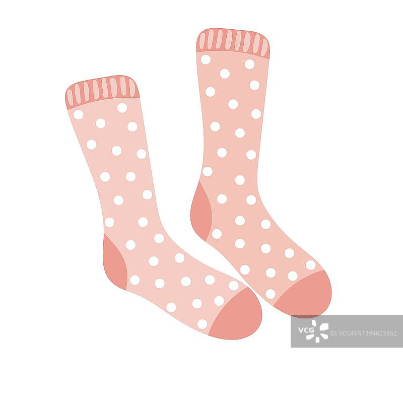一双带圆点图案的温暖的粉色羊毛袜子图片素材