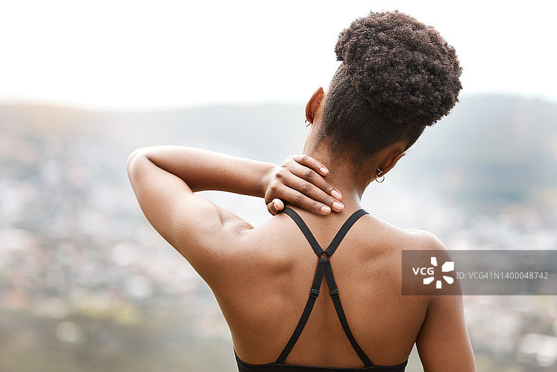 活跃的女性在户外锻炼时颈部疼痛。特写运动员从背后遭受疼痛的身体损伤，造成不适和紧张。关节骨折引起的肌肉扭伤图片素材