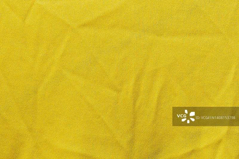 黄色运动服装面料，足球衫面料，运动衫纹理和织物背景。图片素材