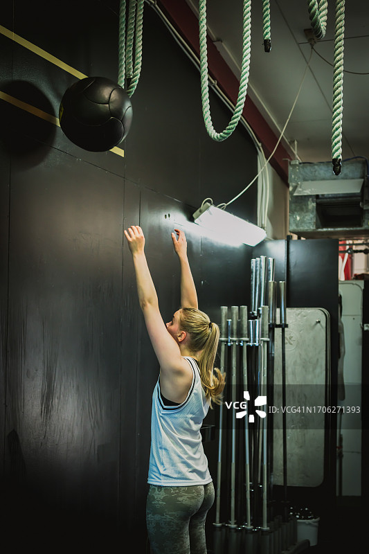 冰岛，女子在健身房用壁球锻炼的后视图图片素材