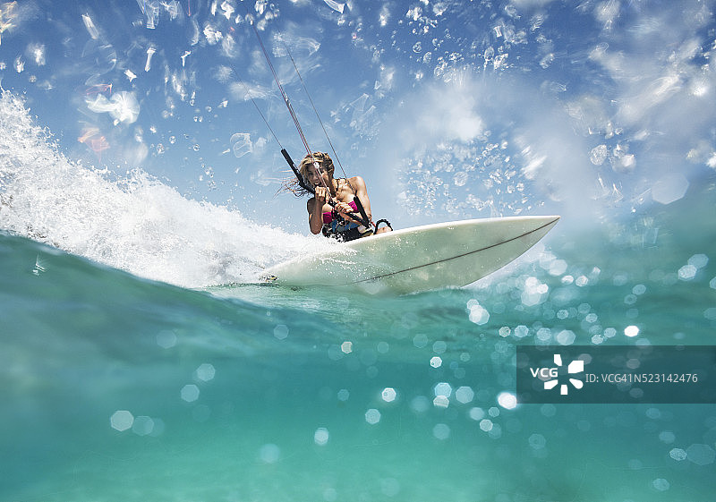 女人喜欢骑在她的风筝冲浪设备图片素材