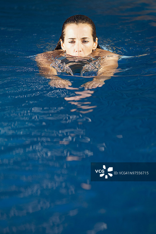 在蓝色的水里游泳的女人图片素材