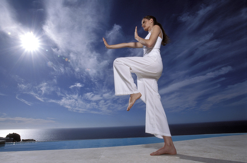 Woman doing yoga on beach图片素材