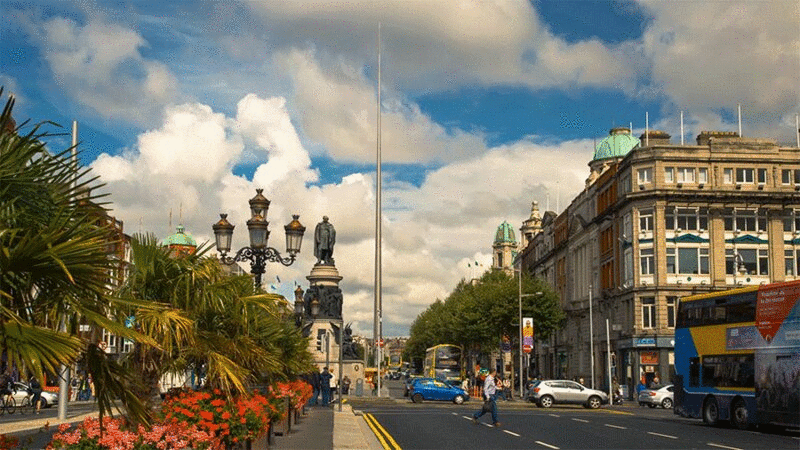 繁忙的街道场景与都柏林塔尖的背景，都柏林，爱尔兰图片下载