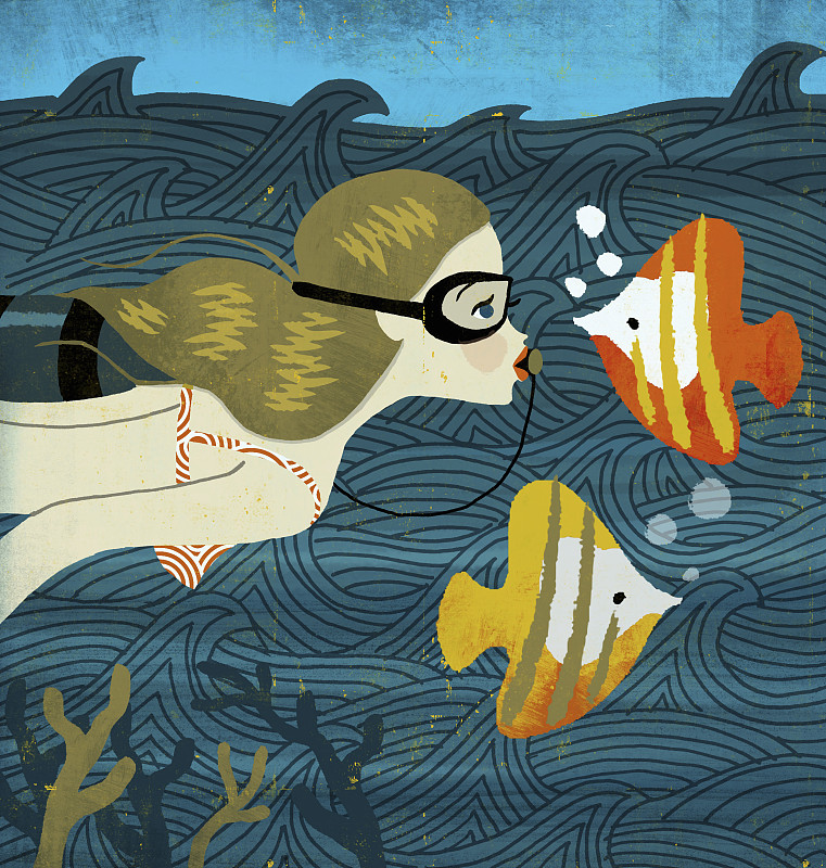 年轻女子浮潜与热带鱼作为双鱼座星座图片素材