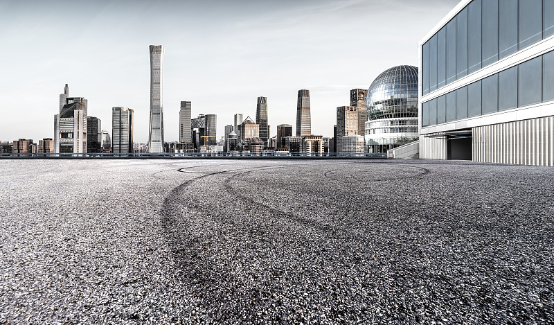 前景现代建筑的城市风光道路平台汽车广告背景图图片下载
