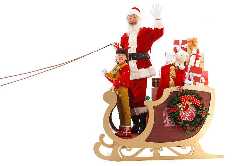 圣诞老人和小女孩坐在雪橇上图片素材