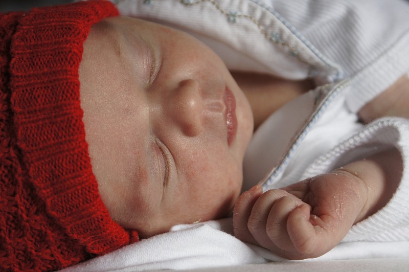 新生儿戴着红帽子睡觉图片下载