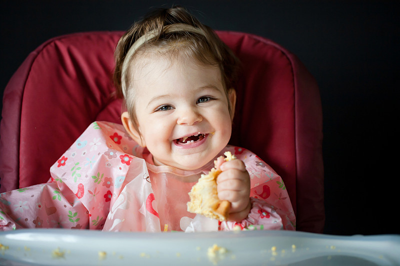可爱微笑的小女孩吃健康的零食图片下载
