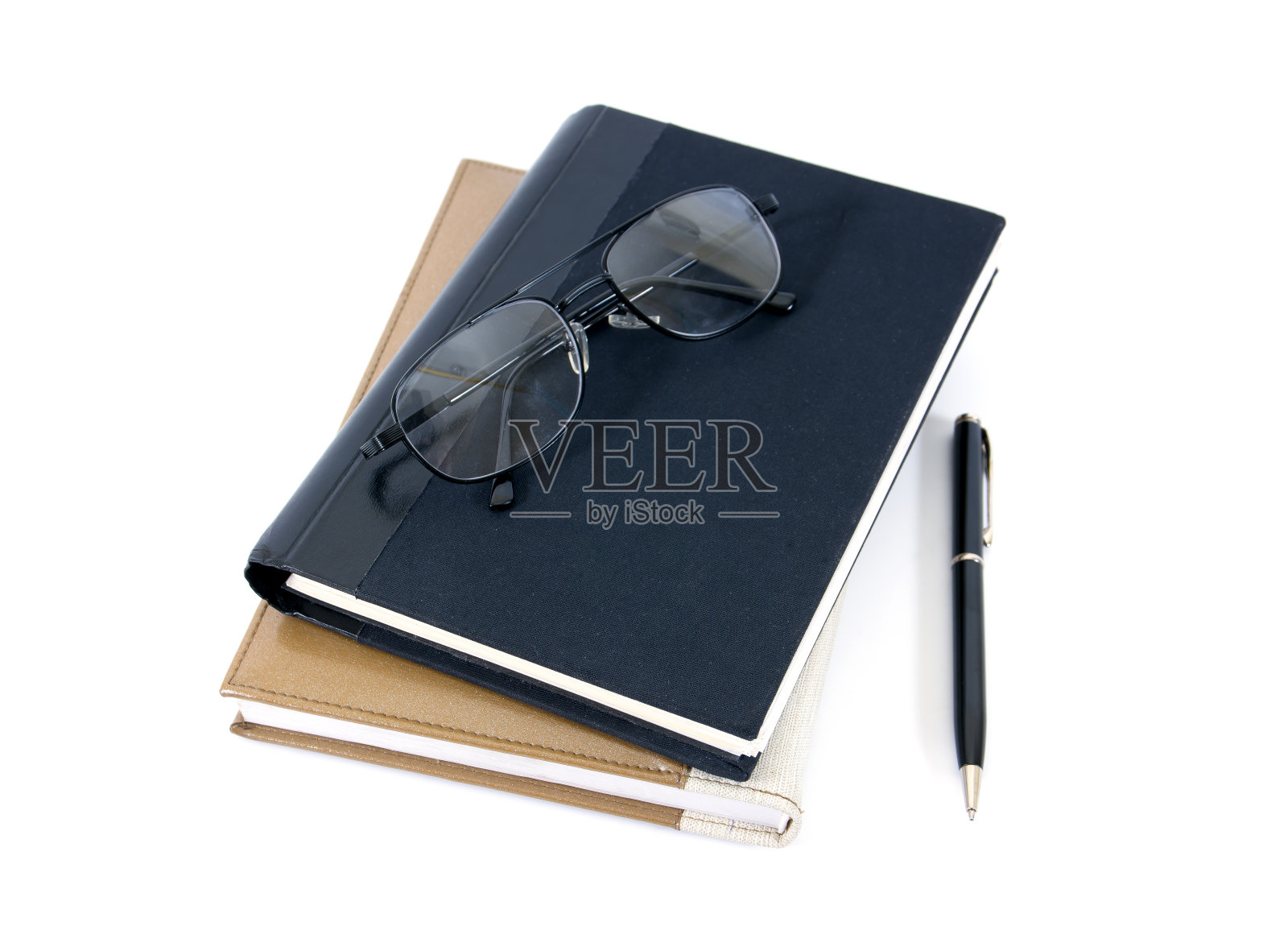 钢笔、书籍和眼镜孤立在白色的背景上照片摄影图片