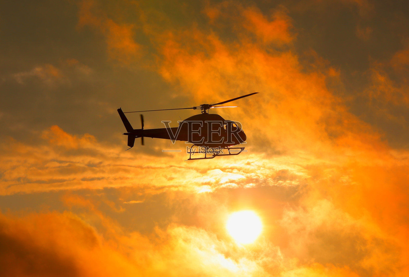 日落时军用直升机的剪影照片摄影图片