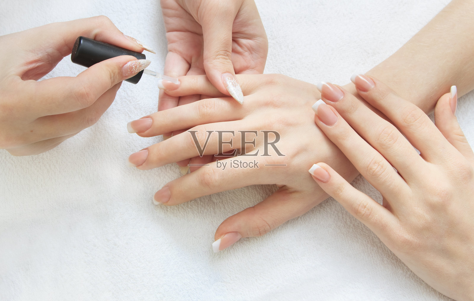 指甲制作——女性双手，覆盖透明珐琅照片摄影图片