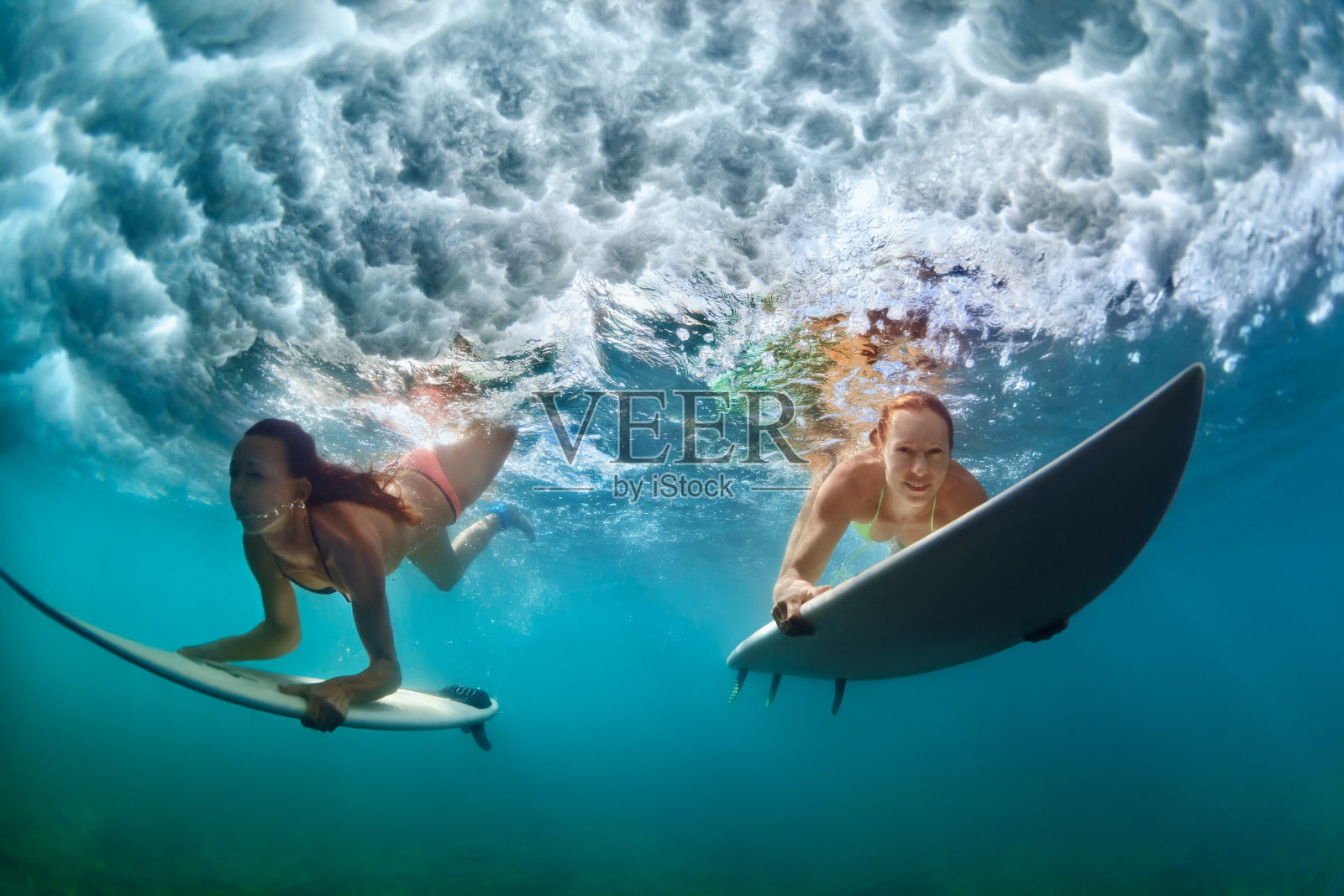 活跃的女孩在比基尼潜水冲浪板行动照片摄影图片