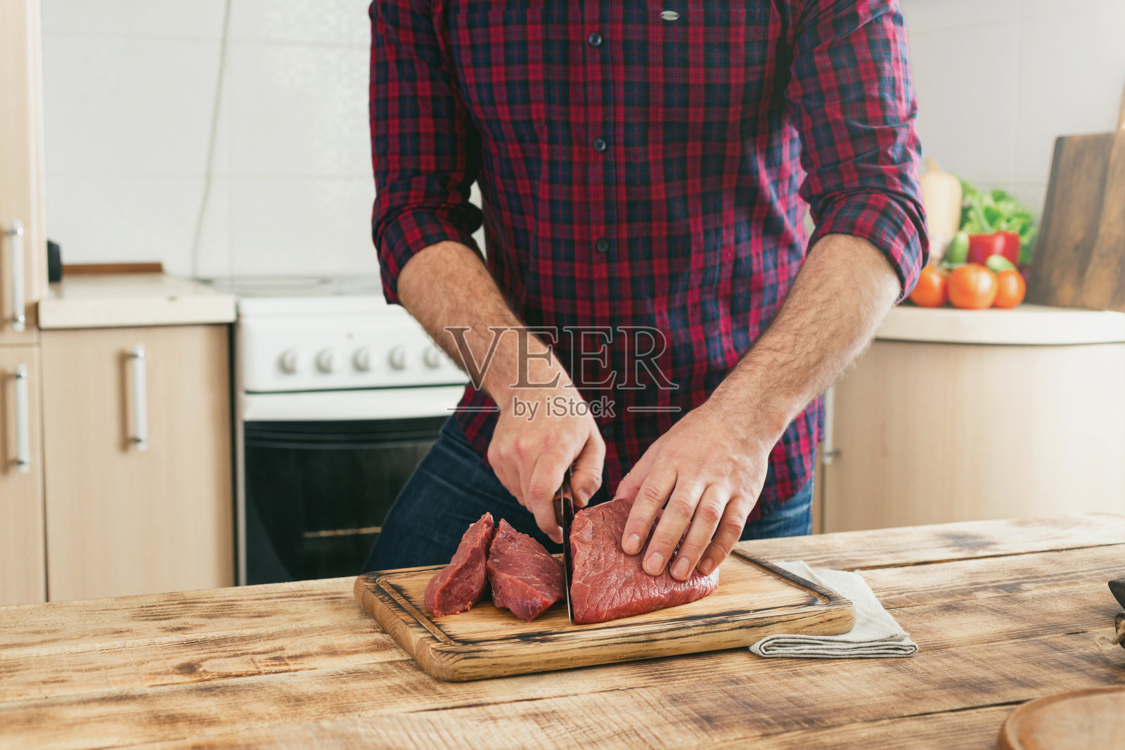 男人在一块木板上切牛肉照片摄影图片