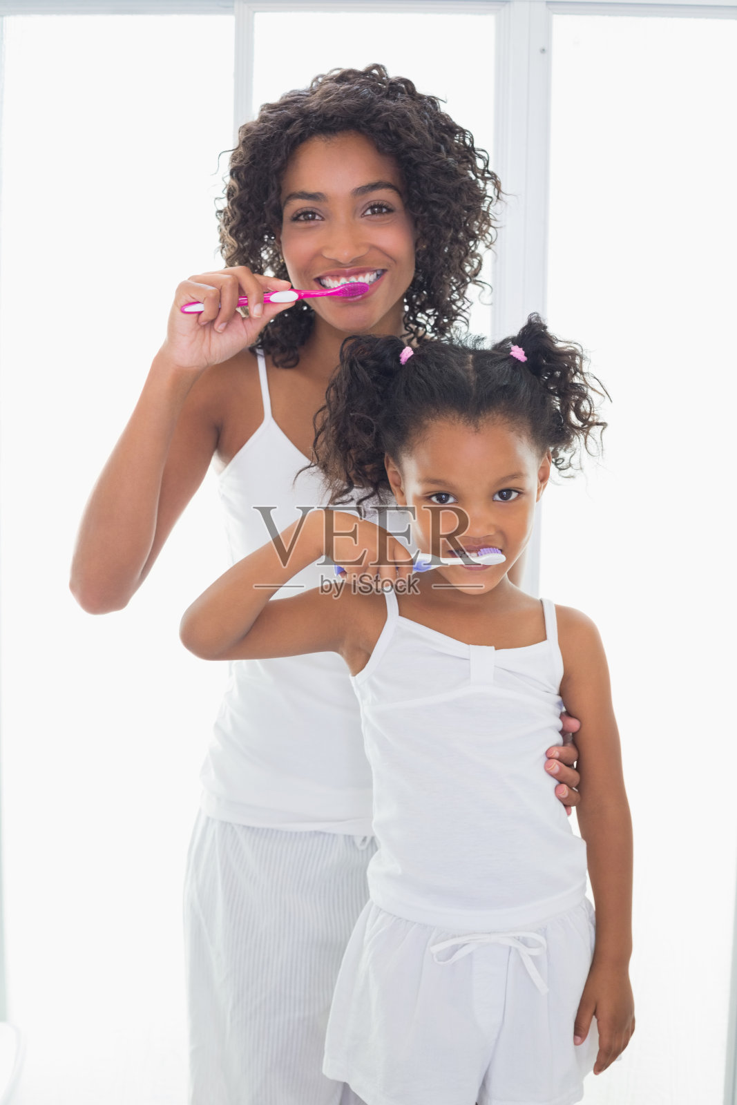 漂亮的妈妈和她的女儿在刷牙照片摄影图片