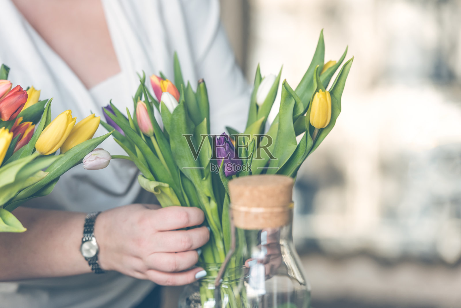 五颜六色的郁金香花束插在玻璃花瓶里照片摄影图片