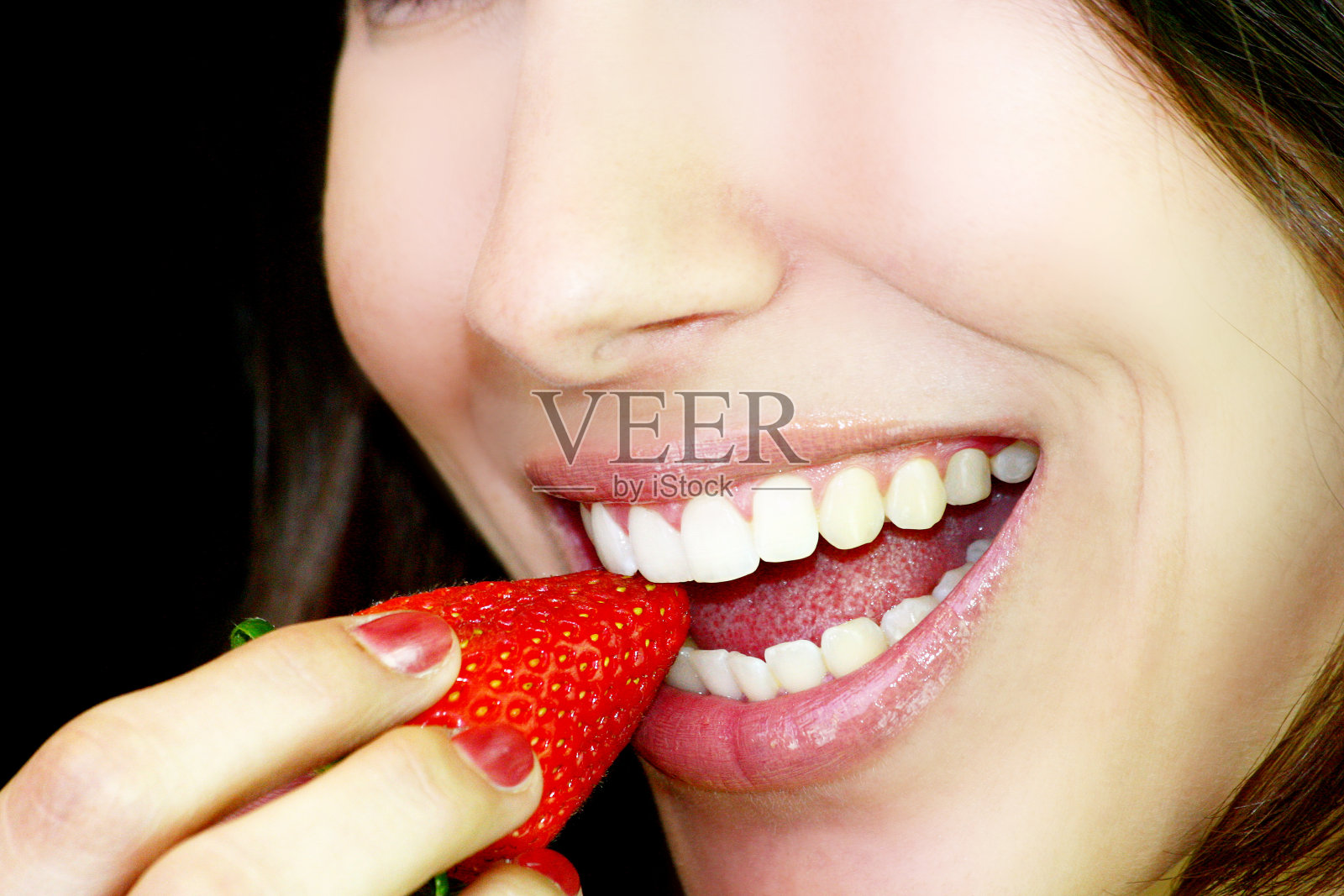 笑容满面的草莓脸和超级白牙的女人照片摄影图片