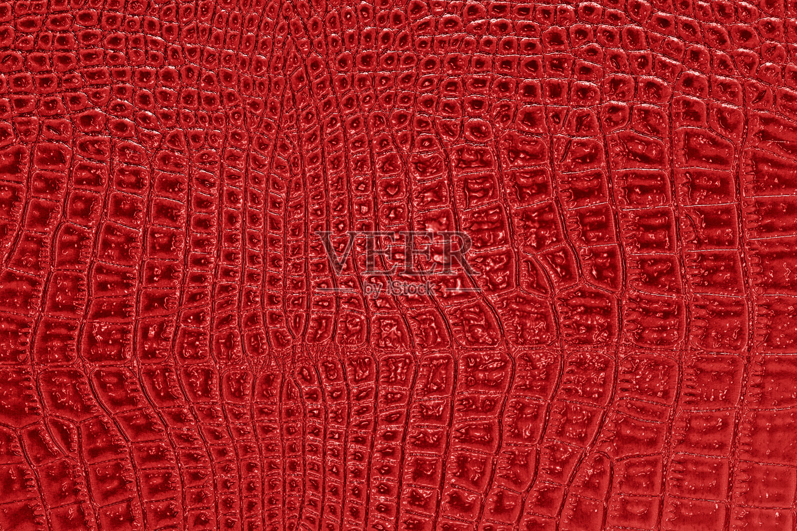 抽象的红色鳄鱼皮，可以用作背景照片摄影图片