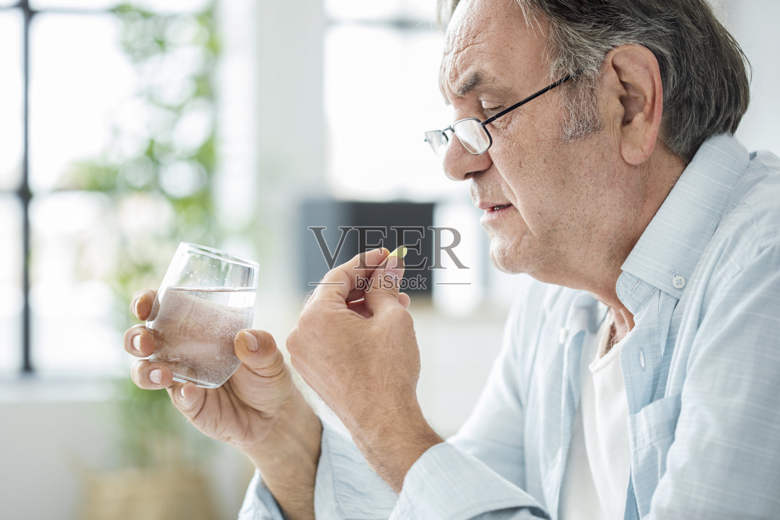 一个老人在吃药照片摄影图片