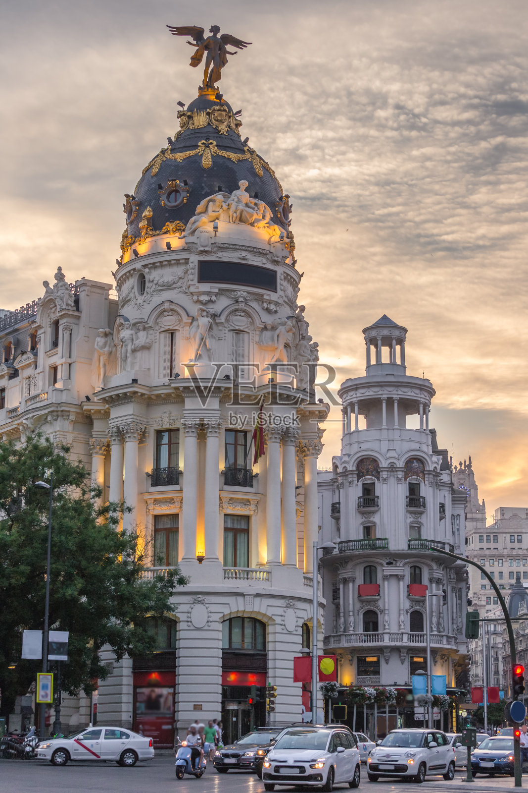 西班牙马德里市中心的gran via主要购物街，日落时分有红绿灯。照片摄影图片