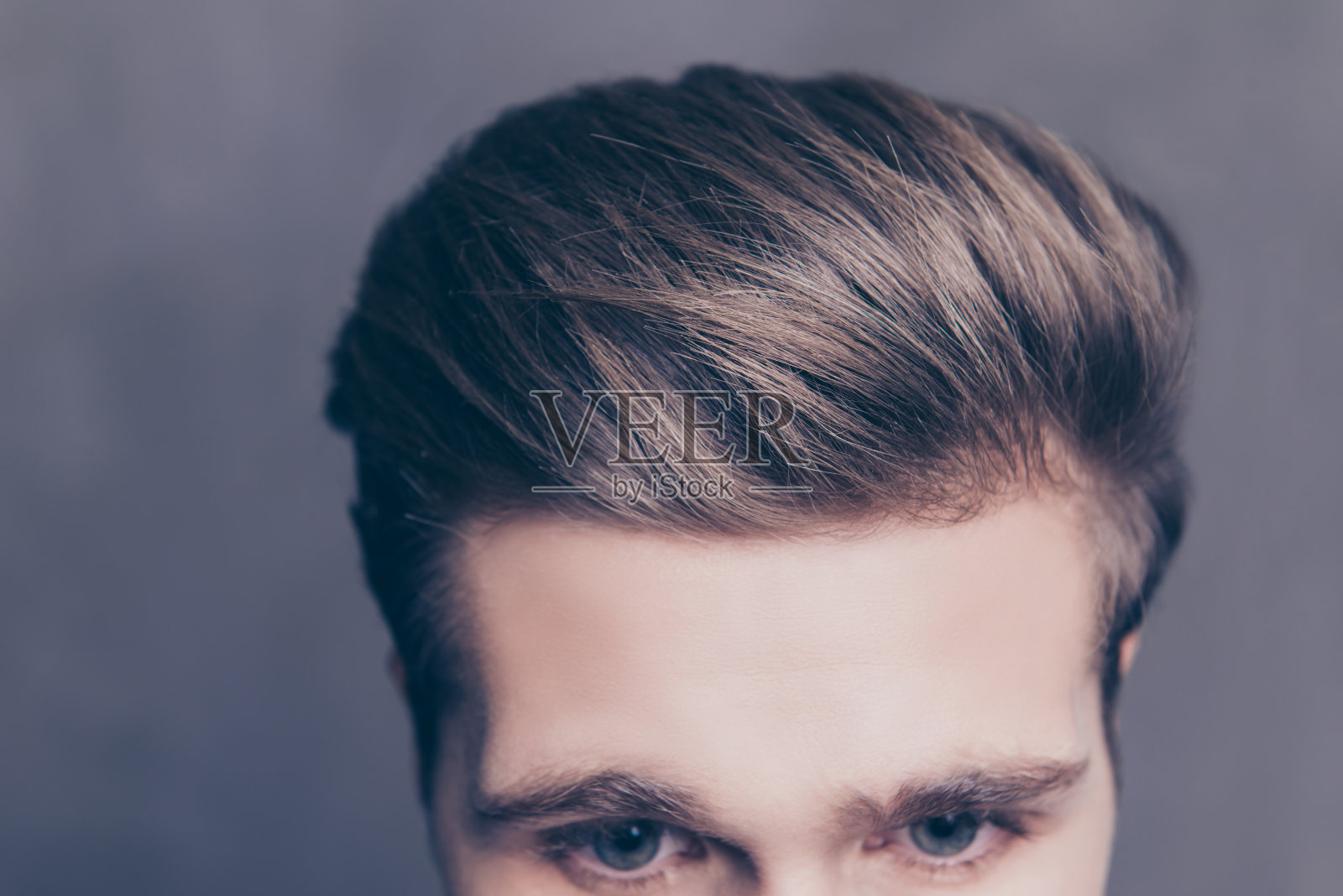 一个年轻男子的头发在灰色背景的特写照片照片摄影图片