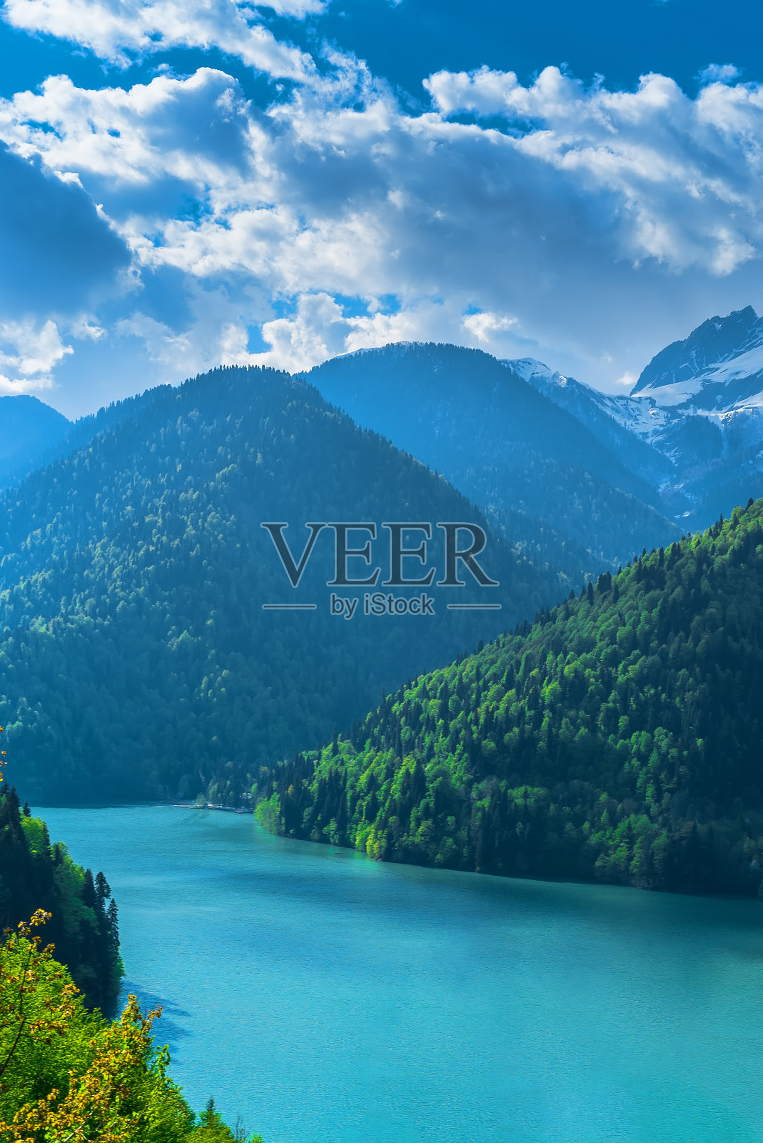 美丽的高加索山脉里的Ritsa湖。青山绿水，蓝天白云。春天的风景。照片摄影图片