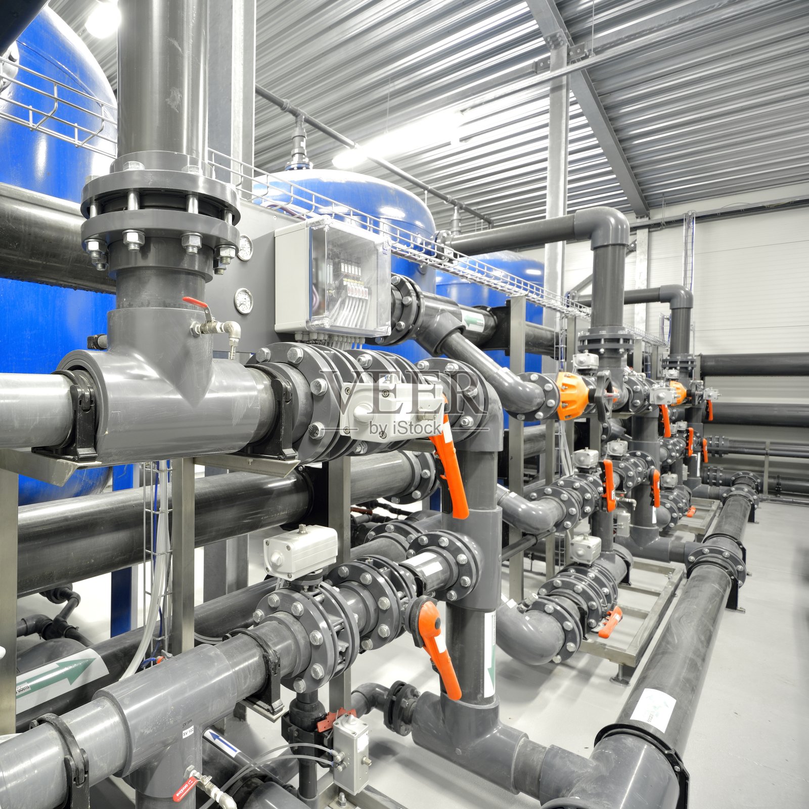 大型工业水处理及锅炉房。闪亮的钢铁管道，蓝色的泵和阀门。照片摄影图片