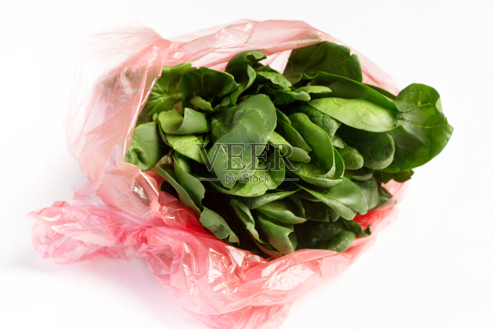 特写新鲜菠菜沙拉在一个塑料袋照片摄影图片