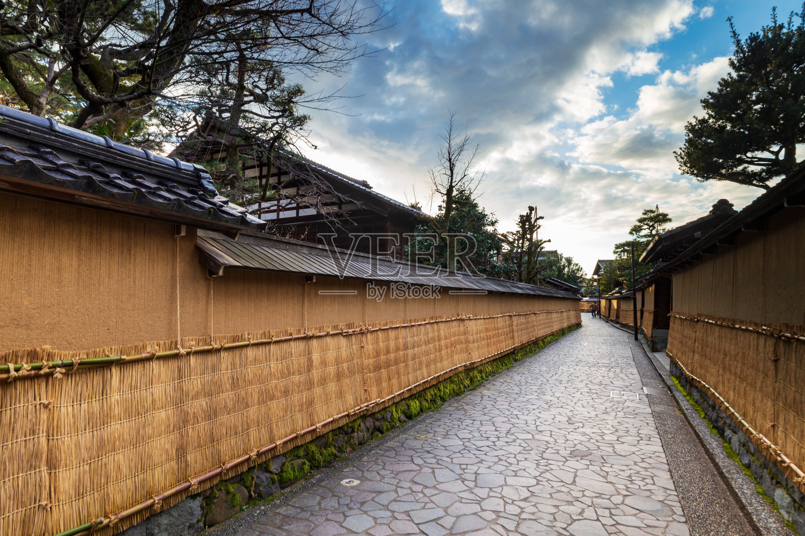日本石川县长崎县或武士区街道上方，天空中布满了土墙，土墙上覆盖着冬季的草席。照片摄影图片