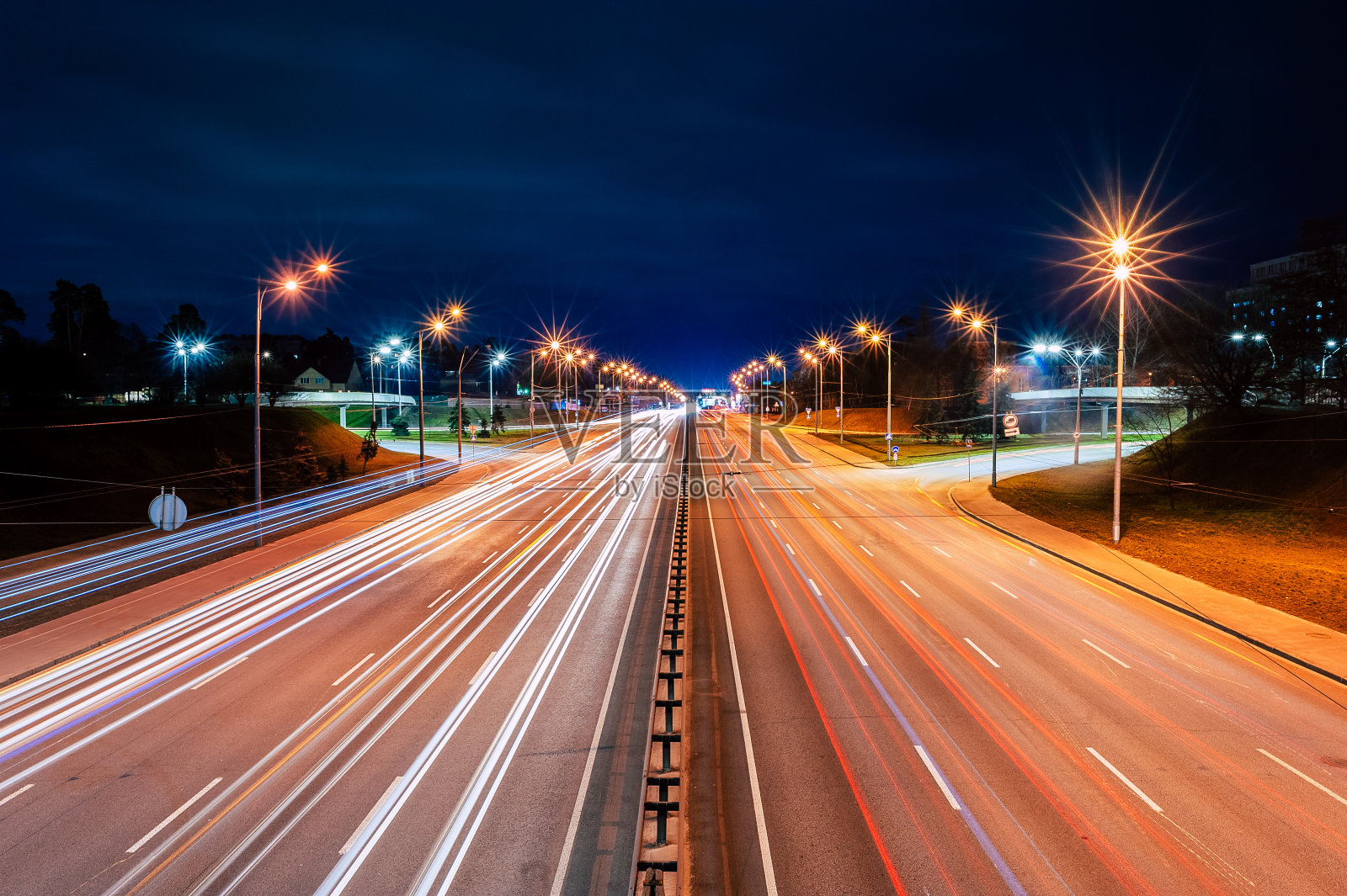 晚上高速公路上汽车和路灯发出的亮光照片摄影图片